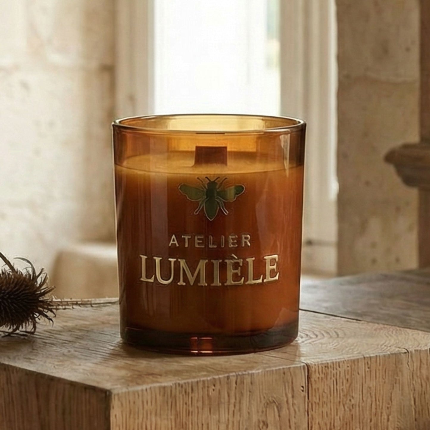 Close-up view of aroma candle in amber glass vessel from Atelier Lumiele