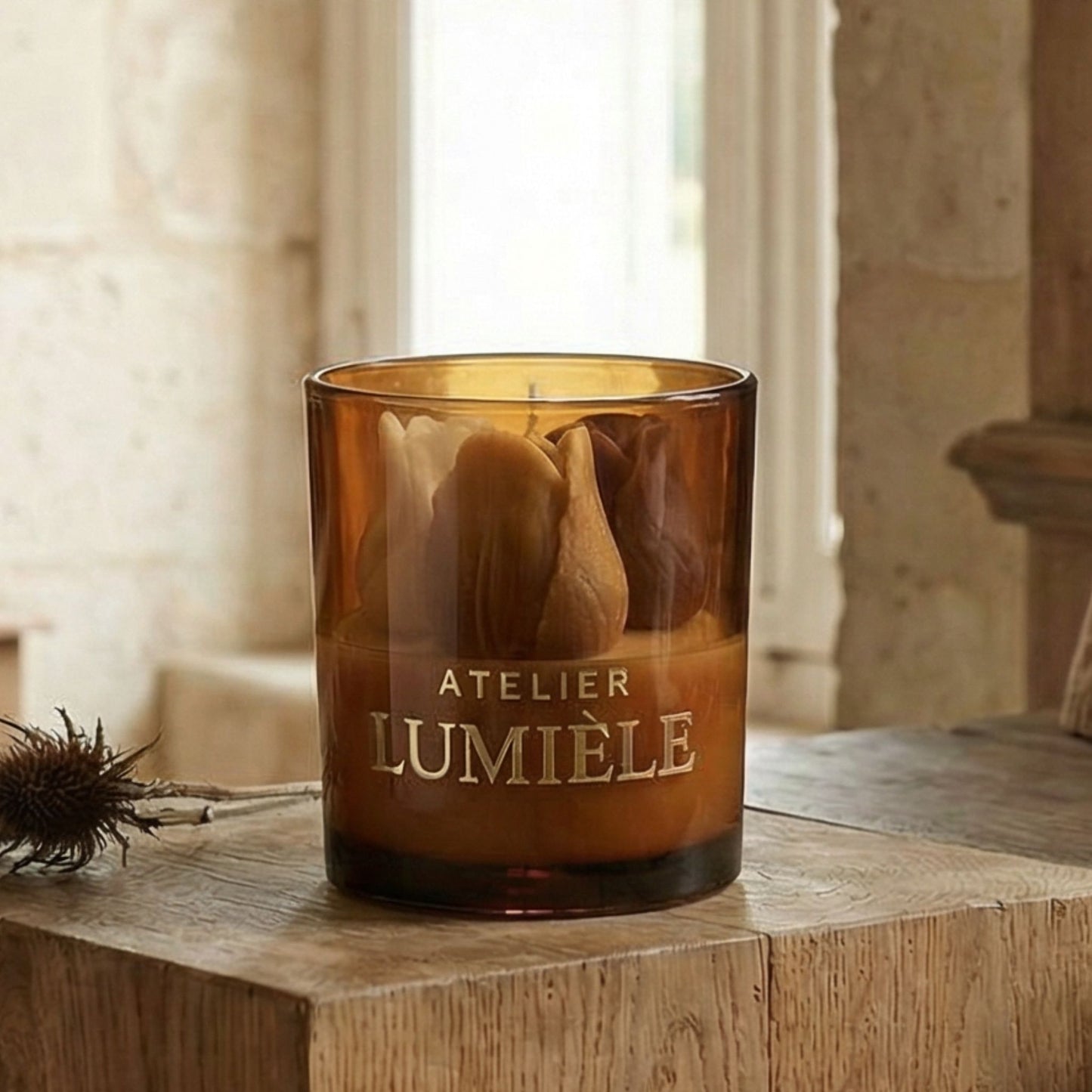 Close-up view of tulip candle wick and wax inside amber glass from Atelier Lumiele